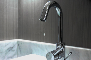 Water dripping from bathroom faucet causes concern for usage and environmental impact
