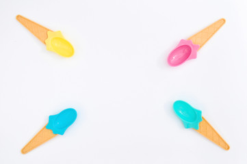 Summer bright ice cream spoons on white background