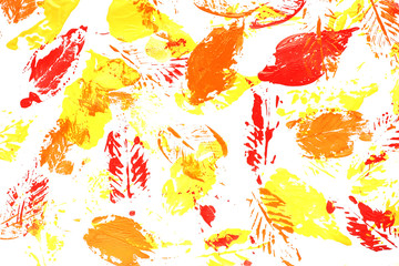 leaves in red, orange and yellow paint on white paper. Isolate Concept autumn...