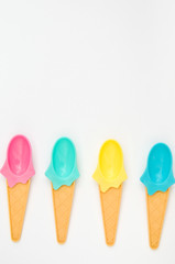 Summer bright ice cream spoons on white background