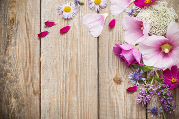 Fototapeta na wymiar summer flowers on old wooden background
