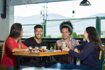 Friends have fun sharing a coffee