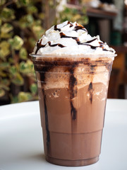 Mocha frappe in plastic cup. Served with whipping cream and chocolate sauce. Freshness drink....