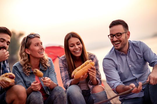 Friends Make Hot Dogs While Camping