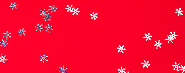 top view snowflake confetti mess on a red background,abstract festive winter background