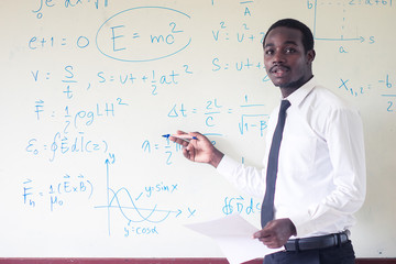 African foreign teacher teaching  science in the classroom.
