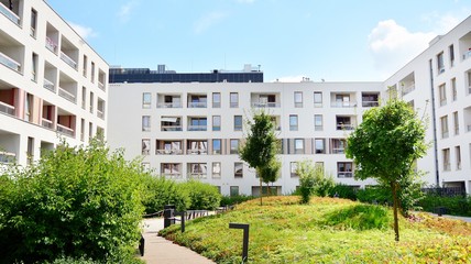 Obraz na płótnie Canvas Modern multi-storey luxury housing concept. Modern apartment building with blue sky and clouds.