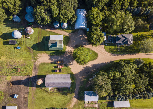 Aerial straight down view of farm house and barns on agricultural acrage and farm.