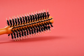 Hairbrush on the red background