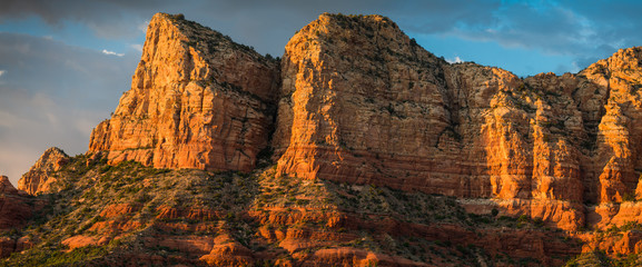 Panorama of beautiful sandstone red rock formations and peaks at golden hour  under a dramatic sky at sunset - Sedona, Arizona
