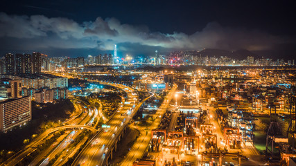 Fototapeta na wymiar Hong Kong port, highway traffic, and the Symphony of Lights show on buildings in city at night. Asia tourism, travel destination, Asian logistic business, or transportation industry concept