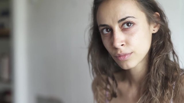 closeup face of young beautiful woman mixed race at home. woman looking sad and serious. Slow motion. Relationship and connections concept