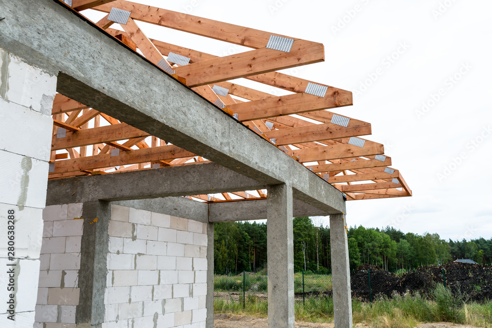 Wall mural Roof trusses not covered with ceramic tile on a detached house under construction, visible roof elements, battens, counter battens, rafters.