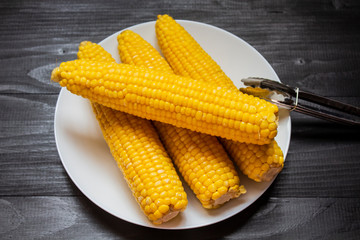 Grains of ripe corn. An ear of corn isolated. Corn on the cob, meal ripe juicy tasty corn. Photo of corn background.Fresh young sweet corn on cobs, closeup. Freshly picked ears of corn in bunch.Fresh 