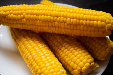 Grains of ripe corn. macro. Corn on the cob, the food is ripe, juicy, delicious corn. Photo of corn background. Fresh young sweet corn on cobs, closeup. Fresh corn on rustic wooden background.