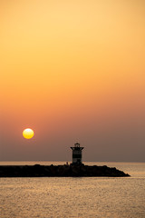 Sunset on the lighthouse of Scheveningen harbor at the summer hottest day ever