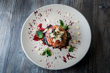 top view on exquisite baked apple dessert with syrop and nuts