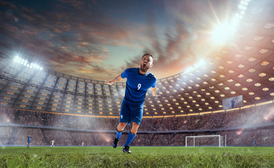 Fototapeta na wymiar Soccer players in action on professional stadium on sunset.