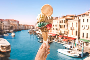 Delicious icecream in beautiful Venezia, Italy in front of a canal and historic buildings - obrazy, fototapety, plakaty