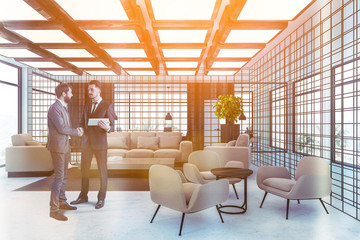 Businessmen in wooden and metal waiting room