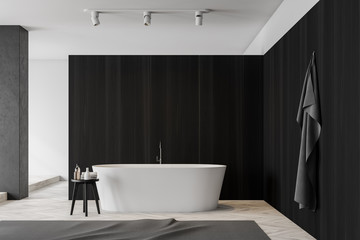 Dark wooden bathroom interior with tub