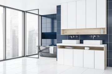Panoramic blue bathroom corner, tub and sink