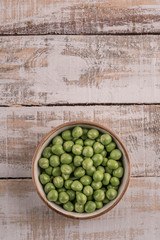 fresh and raw pea seeds on a wooden table