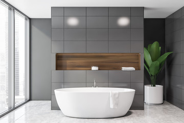 Fototapeta na wymiar Panoramic gray tile bathroom interior with tub