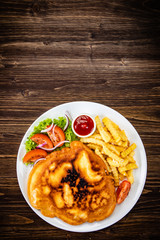 Fried pork chop with french fries and vegetable salad