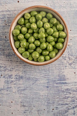 fresh and raw pea seeds on a wooden table