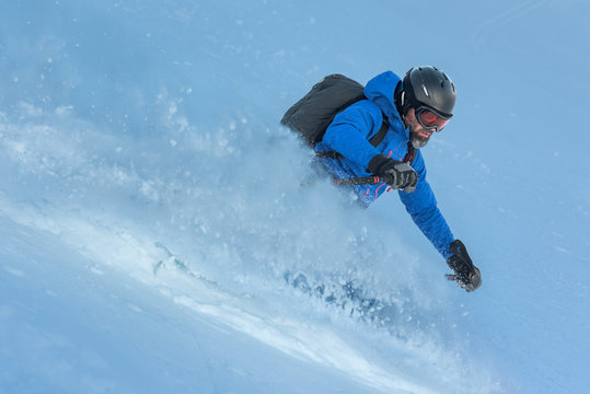 Male skier descending the ski slope