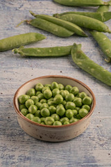 fresh raw peas on a wooden table
