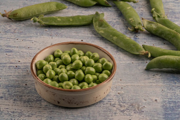 fresh raw peas on a wooden table