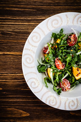 Greek salad on wooden background