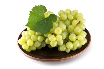 Grapes on a plate on a white background. Fruits