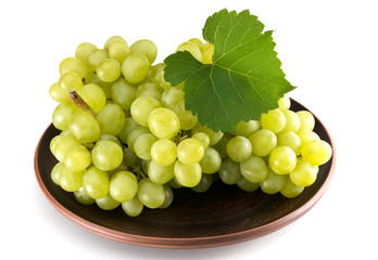 Grapes on a plate on a white background. Fruits