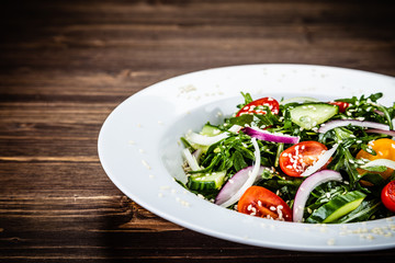 Greek salad on wooden background