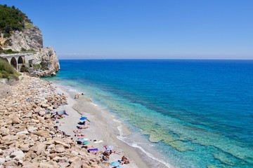 Fototapeta premium Panoramic view of a secluded beach beach between Noli and Varigotti, Liguria, Italy 