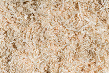 Dry wood shavings background. Wood dust texture. Sawdust pattern closeup. Sawdust floor texture. Top view. Fresh Sawdust close up . Wood industry concept. Eco energy design. Copy space