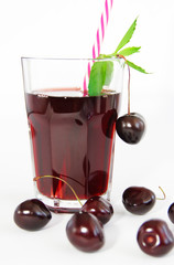 cherry berry and glass with fruit juice with mint leaves