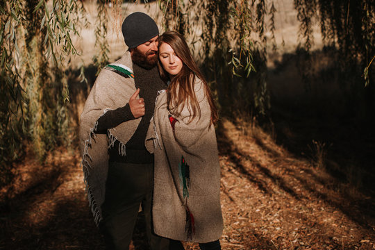 Cozy Couple Wrapped in Blanket at Golden Hour
