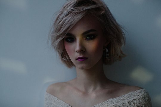 Fashionable girl in dark room with tender light