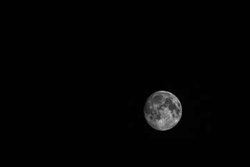 The moon black and white on a dark background 