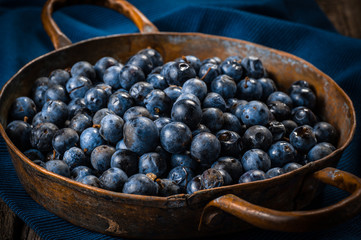 Fresh blueberries in copper dishes. Healthy food