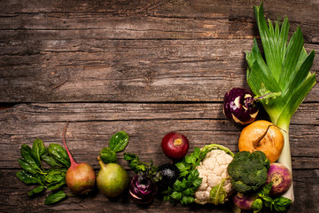 vegetables on a wooden background. Cauliflower, broccoli, radish, parsnip, leek, kohlrabi