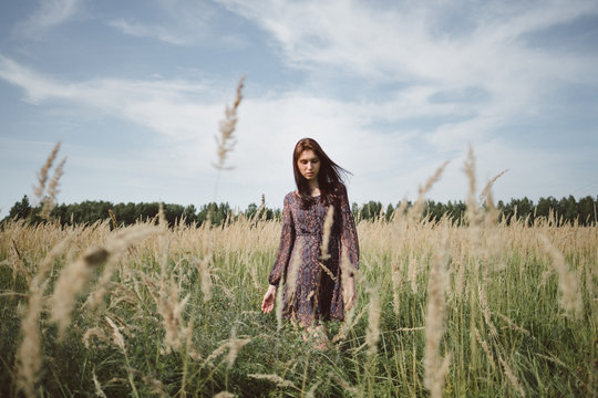 A girl walking in the field.