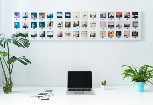 Desktop with laptop and instant photos