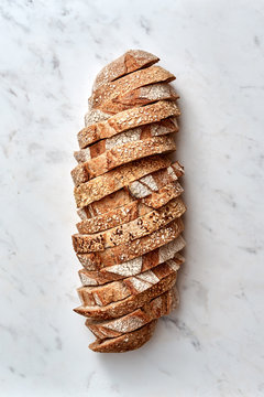 Sliced pieces of rye rural bread with ikunzhutp flax seeds on a
