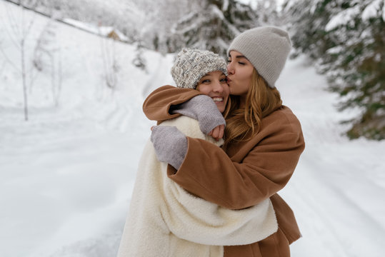 Loving happy girlfriends outdoors in snow