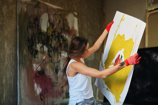Young woman painting.